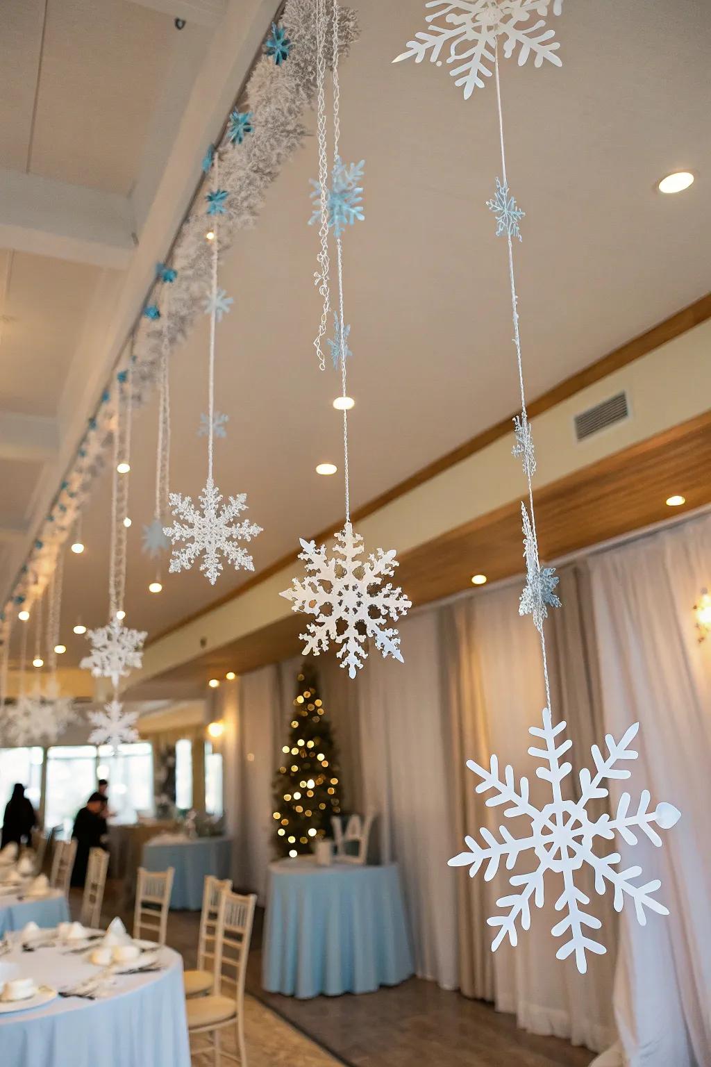 Bring the beauty of falling snow indoors with hanging snowflake decor. ❄️ #WinterDecor #SnowTheme