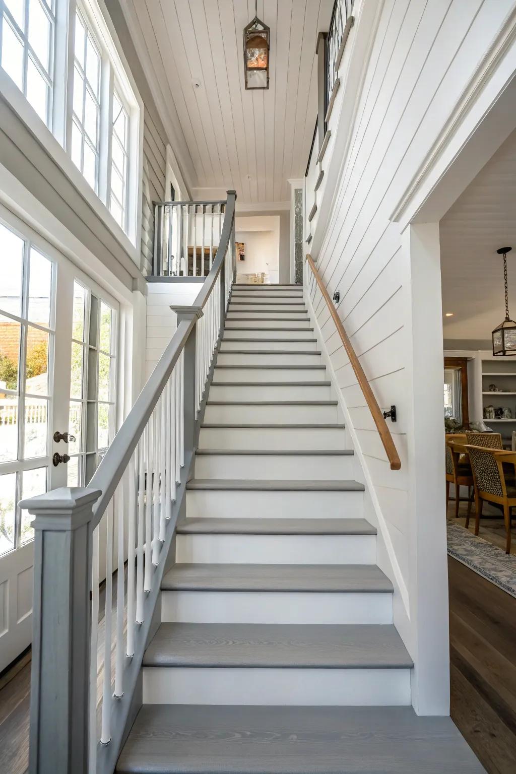 Embrace modern aesthetics with sleek grey rails that complement white steps effortlessly.